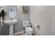 Clean and well-maintained half bathroom with pedestal sink and toilet at 985 Burning Bush Pt, Monument, CO 80132