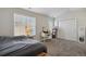 Bright bedroom with window coverings, carpet, and a vanity at 985 Burning Bush Pt, Monument, CO 80132