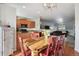 Open concept dining room and kitchen with wooden table and hardwood floors at 985 Burning Bush Pt, Monument, CO 80132