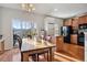 Kitchen and dining area with wooden table, island, and access to deck at 985 Burning Bush Pt, Monument, CO 80132