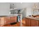 Kitchen with light wood cabinets, black appliances, and hardwood floors at 985 Burning Bush Pt, Monument, CO 80132