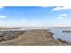 Scenic aerial view of a serene lake with connecting waterways and walking paths in a residential area at 26741 E Arbor Dr, Aurora, CO 80016