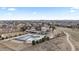 Aerial view showcasing the community clubhouse, pool, and surrounding neighborhood at 26741 E Arbor Dr, Aurora, CO 80016