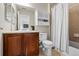 Practical bathroom featuring a vanity with sink, toilet, and shower with curtain at 26741 E Arbor Dr, Aurora, CO 80016