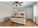 Cozy bedroom featuring hardwood floors, ceiling fan and window with natural light at 26741 E Arbor Dr, Aurora, CO 80016