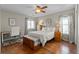 Bedroom with a ceiling fan, hardwood floors, and desk area at 26741 E Arbor Dr, Aurora, CO 80016