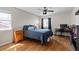 Cozy bedroom with a ceiling fan, hardwood floors, and desk area at 26741 E Arbor Dr, Aurora, CO 80016