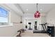 Basement home gym with a view, modern equipment, a unique hanging lamp, and recessed lighting at 26741 E Arbor Dr, Aurora, CO 80016