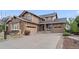 Charming two-story home with a brick and siding exterior and attached garages at 26741 E Arbor Dr, Aurora, CO 80016