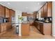 Well-equipped kitchen featuring an island, wood cabinetry, stainless appliances, and double ovens at 26741 E Arbor Dr, Aurora, CO 80016