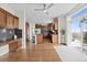 Open kitchen with an island, stainless appliances, wood cabinetry, and access to outdoor patio at 26741 E Arbor Dr, Aurora, CO 80016