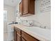 Well-lit laundry room with updated cabinets, sink and laundry machines at 26741 E Arbor Dr, Aurora, CO 80016