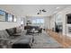 Bright living room featuring a fireplace, plush seating, and large windows at 26741 E Arbor Dr, Aurora, CO 80016