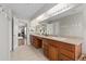 Inviting main bathroom with double sinks, vanity, tiled floors, and ample storage at 26741 E Arbor Dr, Aurora, CO 80016