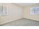 Clean bedroom with neutral carpet, two windows, and electrical outlets at 15136 E Louisiana Dr # 106, Aurora, CO 80012