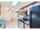 Bright kitchen with granite countertops and sleek black appliances at 15136 E Louisiana Dr # 106, Aurora, CO 80012
