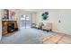 Cozy living room with a stone fireplace, sliding glass doors, and neutral decor at 15136 E Louisiana Dr # 106, Aurora, CO 80012