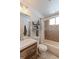 Well-lit bathroom with wood-grain vanity, tiled shower, and large mirror at 11537 Macon St, Commerce City, CO 80640