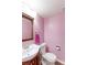 Cozy pink powder room featuring a classic vanity and lighting at 11537 Macon St, Commerce City, CO 80640