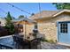 Stone patio offers outdoor dining space with an umbrella-covered table and string lights at 639 S Williams St, Denver, CO 80209