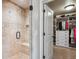 Walk-in shower with seating and a glass door, next to a walk-in closet at 639 S Williams St, Denver, CO 80209