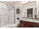 Bathroom featuring a glass-door shower, granite counters, and decorative wreath at 639 S Williams St, Denver, CO 80209