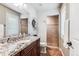 Bathroom featuring granite counters, a shower and a large mirror at 639 S Williams St, Denver, CO 80209