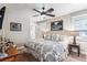 Cozy bedroom with patterned bedding, soft lighting, and a ceiling fan at 639 S Williams St, Denver, CO 80209