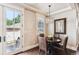 Cozy dining area with a modern chandelier, round table, and wicker chairs for comfortable meals at 639 S Williams St, Denver, CO 80209