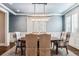 Formal dining room features wainscoting, hardwood floors, and a decorative chandelier at 639 S Williams St, Denver, CO 80209