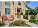 Charming stone home exterior featuring a cozy front porch with seating and manicured landscaping at 639 S Williams St, Denver, CO 80209