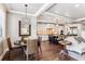 Open kitchen and dining area with white cabinets, granite counters, and modern lighting at 639 S Williams St, Denver, CO 80209