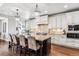 Bright kitchen with white cabinets, granite countertops, a large island, and stainless steel appliances at 639 S Williams St, Denver, CO 80209