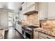 Well-appointed kitchen with stainless steel appliances, granite counters, and custom cabinetry at 639 S Williams St, Denver, CO 80209