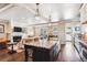 Open-concept kitchen featuring a large granite island, stainless appliances, and hardwood floors at 639 S Williams St, Denver, CO 80209