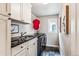 Well-equipped laundry room featuring sleek cabinetry, dark countertops, and modern appliances at 639 S Williams St, Denver, CO 80209