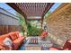 Outdoor living space with a pergola, stone patio, and comfortable seating around a fire pit at 639 S Williams St, Denver, CO 80209