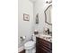 Chic powder room with dark wood vanity, granite countertop, and modern fixtures for guests' convenience at 639 S Williams St, Denver, CO 80209