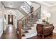 Elegant staircase with wood and wrought iron details, complemented by hardwood floors and a console table at 639 S Williams St, Denver, CO 80209