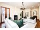Comfortable living room featuring hardwood floors, fireplace, white sofas, and stylish decor creating inviting space at 2435 S Milwaukee St, Denver, CO 80210