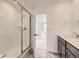Clean bathroom with glass shower doors and a view into a bedroom at 8867 Waterleaf Ln, Littleton, CO 80125