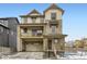 Stylish three-story home with a stone and siding exterior, inviting front porch, and an attached two-car garage at 8867 Waterleaf Ln, Littleton, CO 80125