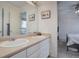 Clean bathroom with double sinks and a view into a bedroom at 6474 S Jericho Cir, Centennial, CO 80016