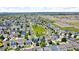 Aerial view showcasing a neighborhood with well-maintained homes and green spaces at 5558 Malta St, Denver, CO 80249
