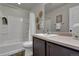Cozy bathroom with a shower-tub combo, vanity, and decorative elements at 5558 Malta St, Denver, CO 80249