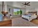 Spacious bedroom featuring a ceiling fan and a large window for natural light at 5558 Malta St, Denver, CO 80249