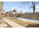 A spacious backyard with a wood fence, mature tree, and a small playhouse for  at 404 S Jasmine St, Denver, CO 80224