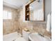 Cozy bathroom featuring neutral beige tiles, vanity, and bath with shower at 404 S Jasmine St, Denver, CO 80224