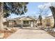 Charming single-story home featuring stone accents, a well-maintained lawn, and a paved driveway at 404 S Jasmine St, Denver, CO 80224