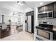 Open concept kitchen with stainless steel appliances, granite counters and views into the living room at 404 S Jasmine St, Denver, CO 80224